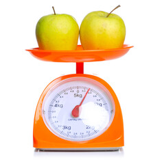 Orange kitchen Scale with two apples on white background isolation