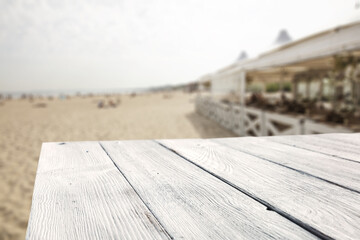 Summer bar on beach and white wooden desk of free space for your decoration 