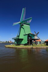 Fototapeta premium Zaanse Schans - Dutch windmill. Summer photo in the Netherlands. Landmarks of the Netherlands.