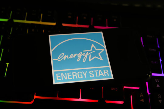 Viersen, Germany - May 9. 2021: Closeup Of Smartphone With Logo Lettering Of Energy Star Label Mark On Computer Keyboard