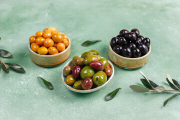 Variety of green and black whole olives.