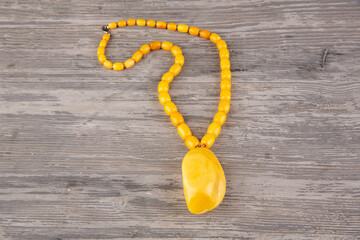 Fototapeta na wymiar Pendant beads made of whole natural royal amber