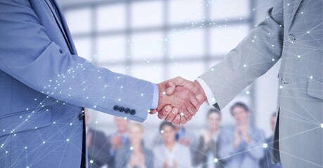 Network of connections over two businessmen shaking hands against business people clapping