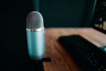 Mic with keyboard in radio or podcast studio. Vintage microphone for broadcast with computer set.