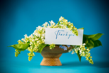 bouquet of white lilacs with greeting card