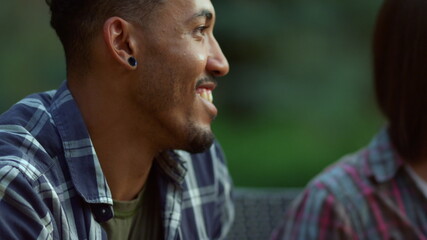 Obraz premium Positive friends gathering together outside. African man smiling at summer party