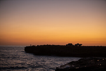 Sunrise golden sky silhouette view of people fishing