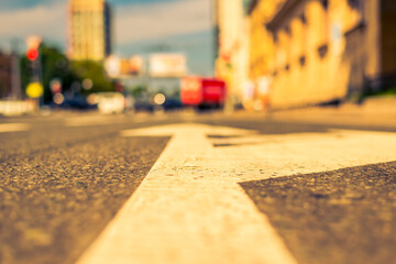 Summer in the city, the street on which cars travel. Close up view of a marking on the pavement level