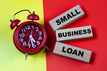 SMALL BUSINESS LOAN - words on colorful background with alarm clock
