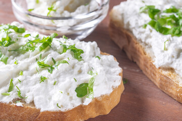 cottage cheese sprinkled with herbs on a slice of bread
