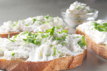 cottage cheese sprinkled with herbs on a slice of bread