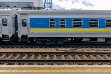 The blue carriage of a passenger train is at the platform. Passenger electric train at the railway station