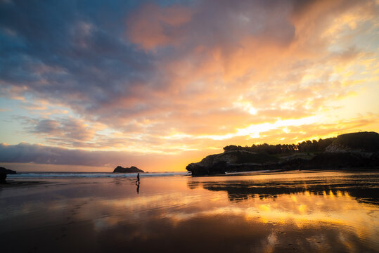 Unrecognizable man enjoying a sunset by the sea on a summer day - Powered by Adobe