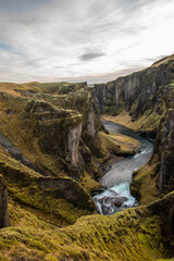 Fjaðrárgljúfur, Iceland mossy green canyon with breathtaking views. Closeup of the river from the top.