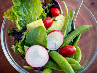Healthy eating salad with lettuce, tomatoes, cucumbers and sugar snap peas