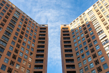 Low angle view of two symmetrical buildings with a space between them