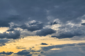 The sky at sunset. Cumulus clouds lit by the rays of the setting sun.