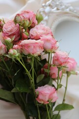 pink roses bouquet in a mirror as decoration