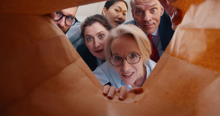 View from inside paper bag of business people looking inside