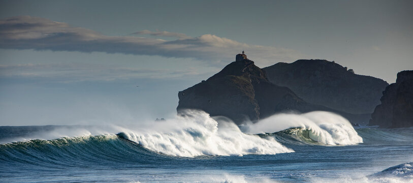 Picturesque view of Cantabrian Sea with fast waves against mounts in Bakio in province of Biscay Spain