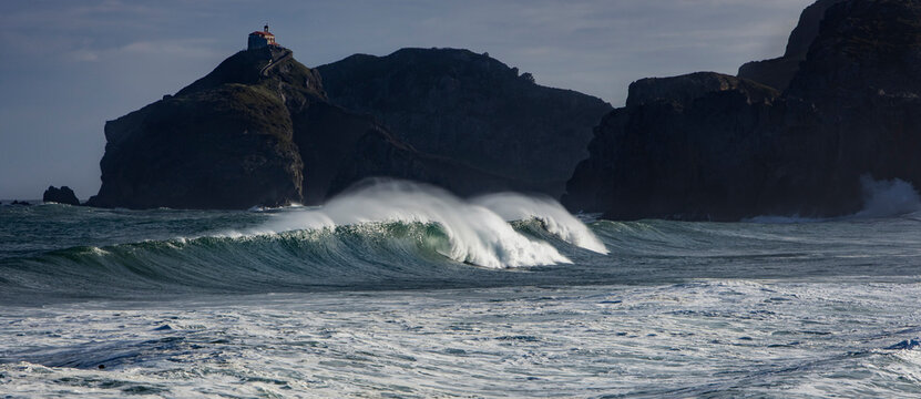 Picturesque view of Cantabrian Sea with fast waves against mounts in Bakio in province of Biscay Spain