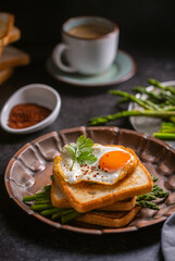 Fresh sandwiches with fried egg served on a vintage metallic plate