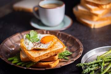Fresh sandwiches with fried egg served on a vintage metallic plate, horizontal
