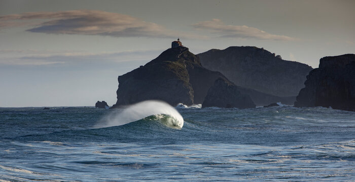 Picturesque view of Cantabrian Sea with fast waves against mounts in Bakio in province of Biscay Spain