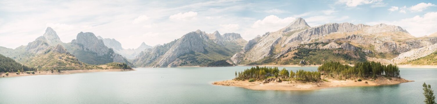 Nice landscape of a huge river surrounded by mountains on a cloudy day