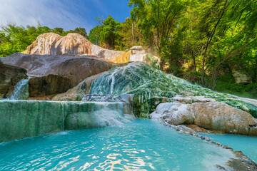 Geothermal pool and hot spring in Tuscany, Italy. Bagni San Filippo natural thermal waterfall in...