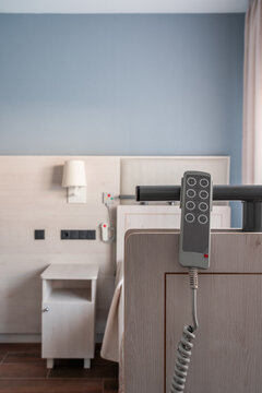 Remote controller hanging on medical bed in bright spacious room in modern hospital