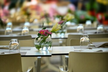 Rows of empty white restaurant terrace tables arranged for dinner