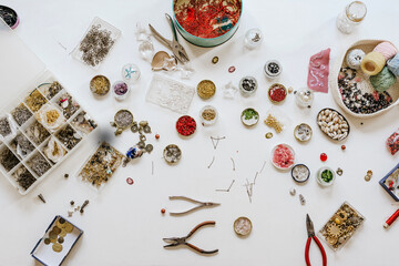Top view of assorted beads instruments and threads with various bugle and spangle for creating accessories
