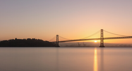 Fototapeta na wymiar San Francisco–Oakland Bay Bridge at sunrise, San Francisco, California, USA