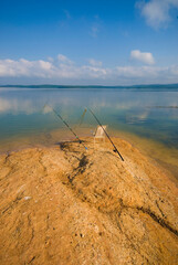 Fototapeta premium Fishing with rod on lake.Two fishing rods on the background of the lake. 