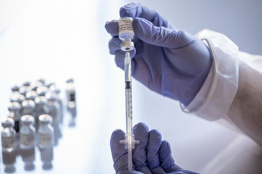 Anonymous female doctor with vaccine bottle and syringe