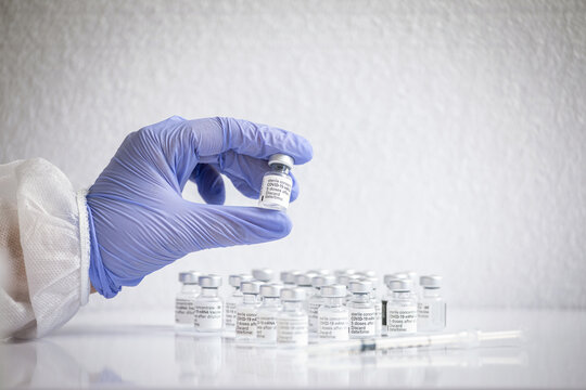 Hands of an unrecognizable female doctor holding a coronavirus vaccine vial