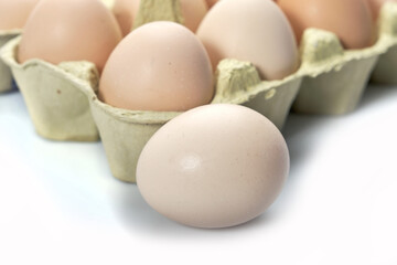 Close-up of eggs in cartoon on white background.