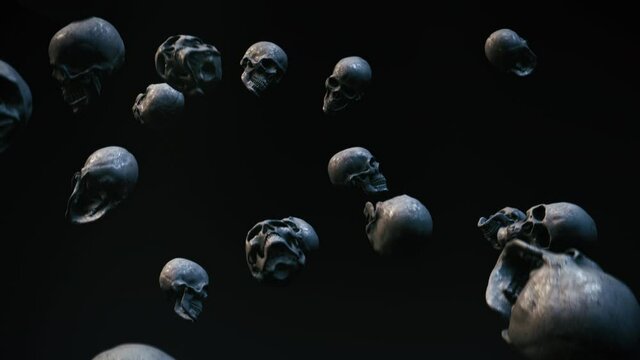 human skulls falling in front of dark background
