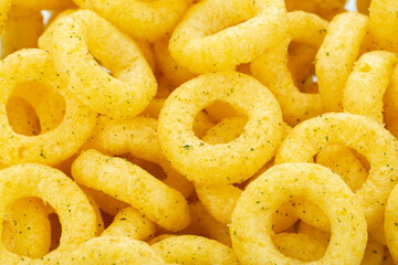Beer snacks. Background of corn rings of sticks with cheese and green onion flavor.