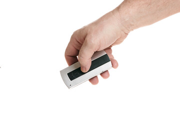 Hand holds a remote control on a white background, template for designers.