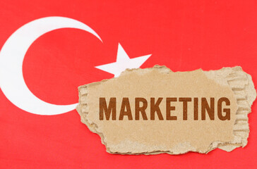 Against the background of the flag of Turkey lies cardboard with the inscription - marketing