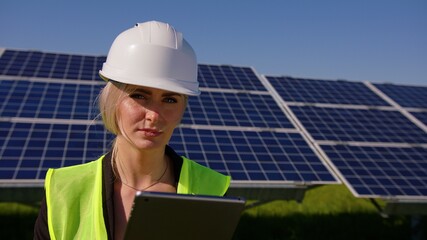Female ecological engineer uses digital tablet and collects efficient information about solar...