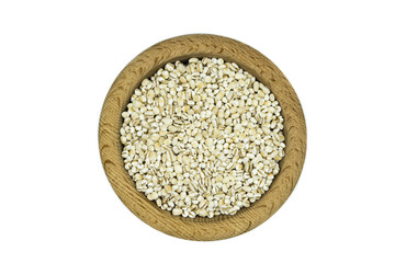 Pearl barley in wooden bowl isolated on white background top view