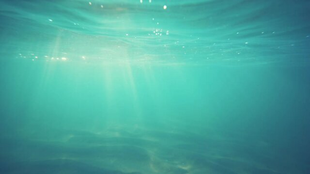 Underwater ocean waves and sun rays