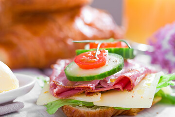 Croissant with ham cheese and cucumber