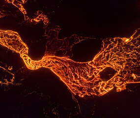 From above the magma of the volcano runs in the form of rivers of lava across the ground in Iceland