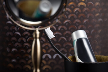 A sharp toothbrush and toothpaste behind the obscure mirror.