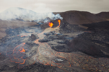 From above magma sparks out of the volcano hole and run like rivers of lava over the ground in Iceland