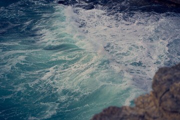 Sea waves bumping against the rocky shore